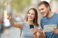 Couple of tourists checking location on the street