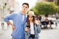 Couple of tourists consulting smartphone gps in the street searching locations in new city Royalty Free Stock Photo