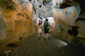 Couple of tourists exploring the cave. The interior of the cave. Touristic hiking route. Concept of excursions and attractions.