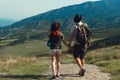 A couple of tourists in hats, a man with a backpack. walk against the backdrop of the mountains. Mtskheta. Georgia Royalty Free Stock Photo