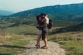 A couple of tourists in hats, a man with a backpack. walk against the backdrop of the mountains. Mtskheta. Georgia romance, kiss, Royalty Free Stock Photo