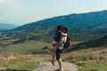 A couple of tourists in hats, a man with a backpack. walk against the backdrop of the mountains. Mtskheta. Georgia romance, kiss, Royalty Free Stock Photo