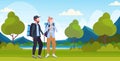 Couple tourists hikers with backpacks and stick trekking hiking concept man woman travelers on hike beautiful river