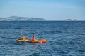 A couple of tourists kayaking around the old port of Dubrovnik in Croatia