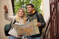 Couple of tourists with map planning trip on street Royalty Free Stock Photo