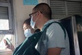 Couple of tourists in medical masks on a train