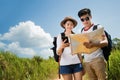 Couple tourists opening the map tourist women she is open to smartphone