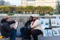 Couple of tourists posing for street painter, paris, France.