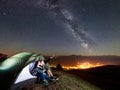 Couple tourists resting at night camping under stars Royalty Free Stock Photo