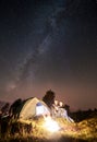 Couple tourists resting at night camping under stars Royalty Free Stock Photo