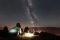 Couple tourists resting at night camping under stars Royalty Free Stock Photo