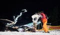 Friends skiers having fun at ski resort in the mountains in winter, skiing at night Royalty Free Stock Photo