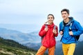 Couple tourists standing on the mountains background