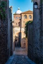 Couple of tourists strolling through the narrow streets of the medieval city of Caceres