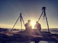 Couple tourists take pictures to background of hills and sky