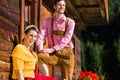 Couple in traditional clothing front of mountain hut Royalty Free Stock Photo