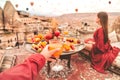 Couple Travel in Cappadocia Colorful hot air balloons flying over the valley sunrise time with special breakfast travel