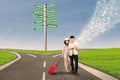 Couple travel at cross road using e-tablet Royalty Free Stock Photo