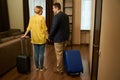 Couple with travel suitcases check into a hotel room Royalty Free Stock Photo