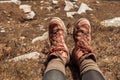 Couple of traveler hiker feet with trekking shoes sitting on top of the mountain in Carpathians with the beautiful view