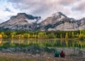 Couple traveler relaxing on coastline in Wedge pond at Kananaskis country