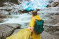 Couple travelers follow holding hands in mountains glacier