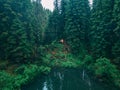 couple travelers hikers reach mountain lake in forest