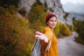 Couple travelers Man and Woman follow holding hands at foggy mountains landscape on background Royalty Free Stock Photo