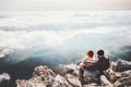 Couple travelers Man and Woman sitting on cliff