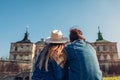 Couple of travelers relaxes enjoying view of Pidhirtsi castle. Ancient architecture landmark. Tourism in Westerm Ukraine Royalty Free Stock Photo