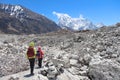 Couple of travelers walks on glacier in Himalayas