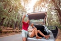 Couple traveling by car in the forest Royalty Free Stock Photo