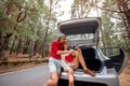 Couple traveling by car in the forest Royalty Free Stock Photo