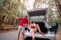 Couple traveling by car in the forest Royalty Free Stock Photo