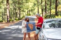 Couple traveling by car in the forest Royalty Free Stock Photo