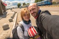 Couple traveling on a motorcycle on the background of the road and train