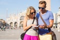 Couple traveling and reading tourist guide