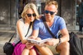 Couple traveling and reading tourist guide book