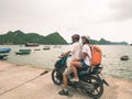 Couple traveling together by motorbike, adult man and woman having fun at Halong Bay and Cat Ba island, famous tourist destination Royalty Free Stock Photo