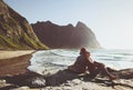 Couple traveling together relaxing on Kvalvika beach in Norway