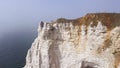 Couple traveling together on white cliff edge on blue sky background, lifestyle concept. Action. Young couple of Royalty Free Stock Photo