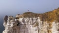 Couple traveling together on white cliff edge on blue sky background, lifestyle concept. Action. Young couple of Royalty Free Stock Photo