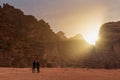 Couple travelling in Wadi Rum desert in Jordan, enjoying beautiful sunrise in the morning