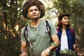 Couple trekking together in a forest Royalty Free Stock Photo