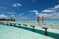 Couple on a beach jetty at Maldives