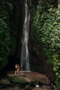 Couple at a tropical waterfall. The couple travels to the island of Bali in Indonesia. A woman and a man at a beautiful waterfall Royalty Free Stock Photo