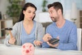 couple trying to break piggy bank with hammer Royalty Free Stock Photo