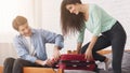 Couple trying to close valise, packing suitcase Royalty Free Stock Photo