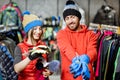 Couple trying winter clothes in the shop