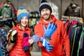 Couple trying winter clothes in the shop